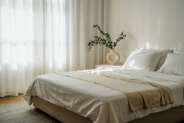 Bright Bedroom Interior With Eucalyptus In Vase,Cozy Bed,And Sheer White Curtains