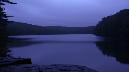 Fototapeta premium Serene twilight view of a tranquil lake surrounded by lush woodlands