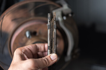 Disc brake and asbestos brake pads at car garage