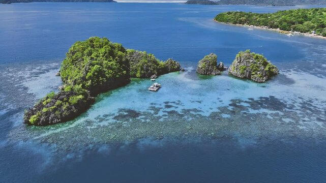4K Drone View Of Seven Islands of Siete Pecados, Coron island, Palawan, Philippines
showcases the cluster of seven distinct islands surrounded by vibrant blue and crystal clear waters