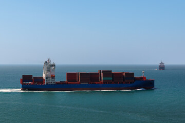container ship carrying goods for international import export, business and industry regarding...