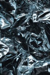 Abstract metallic texture with crumpled foil reflecting light creating a modern and futuristic design with dark and light shades for a dynamic visual effect