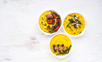 Delicious dishes with corn porridge and grilled vegetables on a white background. Traditional...