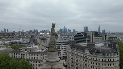 Stunning 4K aerial footage captured by drone, showcasing a smooth orbit around Admiral Lord Nelson atop Nelson’s Column in Trafalgar Square, London.