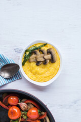Grilled vegetables in a frying pan and porridge with corn grits. Healthy food for every day.