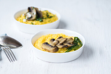Bright polenta with frozen mushrooms, red peppers and tomatoes healthy food.