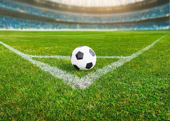 a soccer ball on the green grass on the line on corner in soccer stadium. corner kick.
