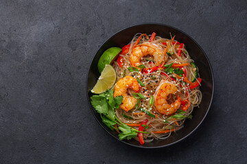 rice noodles with shrimps and  vegetables in bowl
