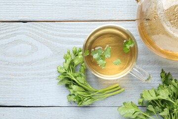 Healthy parsley tea on grey wooden table, flat lay with space for text. Detox drink