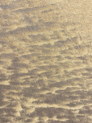 Volcanic sand pattern wavy texture on the beach of El Medano, Tenerife, Canary Islands, Spain. Abstract nature background for design.