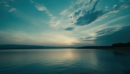 Naklejka premium Serene sunset over tranquil lake. Cloudscape above calm water