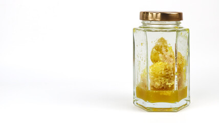 Natural organic honey in glass jar isolated - on white background