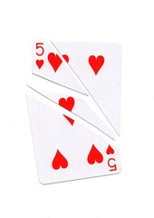 A playing card in the suit of hearts cut into sharp pieces.