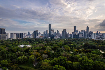 Fototapeta premium Beautiful Aerial view Green Park With Downtown Skyscrapers Background.