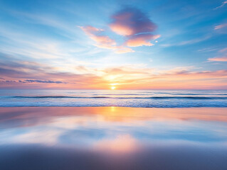 serene sunset over calm ocean, with soft pink and blue clouds reflecting on water surface, creating tranquil atmosphere. gentle waves lap against shore, enhancing peaceful scene