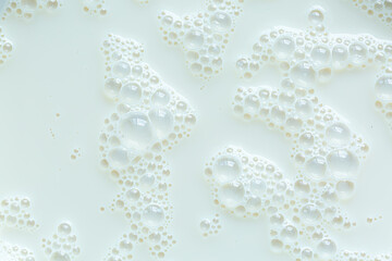 Background, close-up macro milk texture,Macro milk surface close-up,Macro milk texture,White surface of milk and bubbles and ripples from above birds eye view