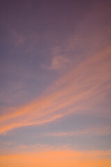 Pastel twilight sky with soft pink and orange clouds and a delicate crescent moon. A tranquil and dreamy background perfect for evening, minimalism, nature, or meditation and wellness concepts.