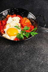 Fried egg tomatoes shakshuka vegetable dish appetizer fresh delicious gourmet food background on the table rustic food top view copy space vegetarian  food