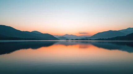 Serene lake sunrise reflecting mountains. Calm waters mirror the vibrant sunrise hues over distant mountain ranges. Tranquil morning light paints the scene