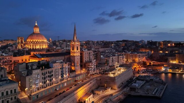 Breathtaking sunset aerial view of Valletta, Malta showcasing historic architecture and vibrant waterfront