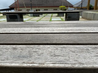 Close-up of weathered wooden bench planks. Rustic texture, natural lines. Outdoor architecture in...