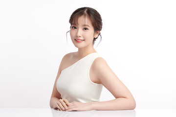 A beautiful young Asian woman with clean, fresh skin against a white background. Skincare, facial...