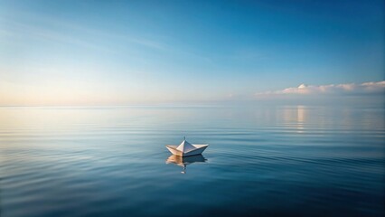 A solitary paper boat floats serenely on the tranquil ocean's surface under a vast, clear sky at dawn, reflecting the peaceful beauty of nature's untouched expanse.