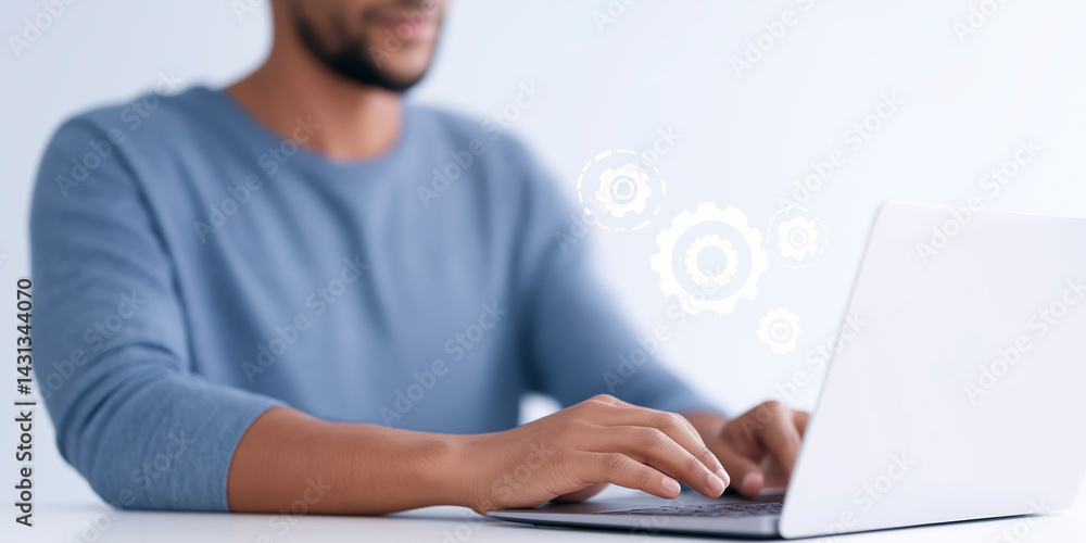Poster focused man working on laptop with gears symbolizing technology and innovation in a modern workspace