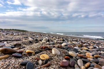 Pebbled coastal scene: A textured beachscape under a cloudy expanse of sky