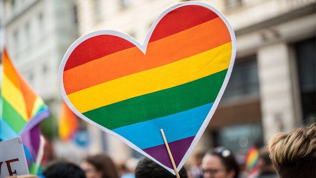 Rainbow heart sign at pride parade celebrating love and equality for all