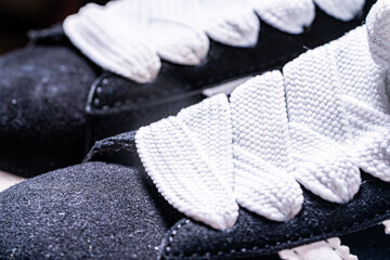 Black sneakers with white laces. Close-up.