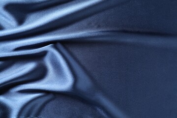 Fototapeta premium Blue crumpled silk fabric as background, top view