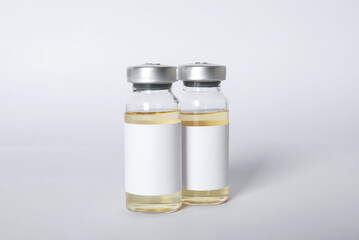 Hepatitis vaccine in glass vials on light background, closeup