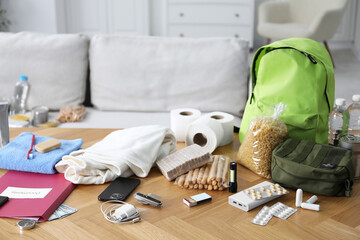 Survival kit. Different emergency supplies on wooden table indoors