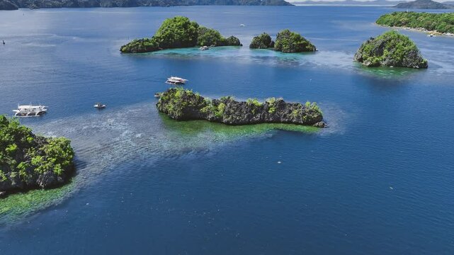 4K Drone View Of Seven Islands of Siete Pecados, Coron island, Palawan, Philippines
showcases the cluster of seven distinct islands surrounded by vibrant blue and crystal clear waters