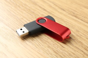 One flash drive on wooden background, closeup