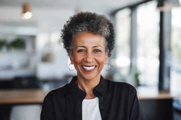 Fototapeta premium Portrait of a smiling senior african american businesswomen in a modern office in Berlin