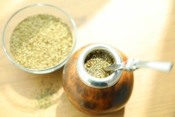 Traditional yerba mate tea on wooden table, above view