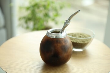 Traditional yerba mate tea on wooden table indoors