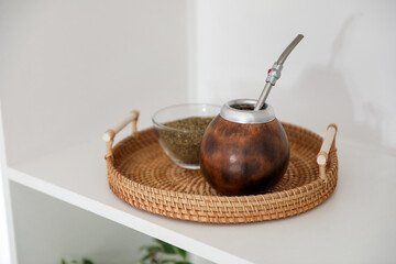 Traditional yerba mate tea on shelving unit indoors