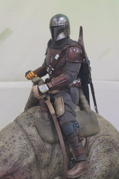 GUAYAQUIL, ECUADOR - AUG 06, 2023: Collectible figure of The Mandalorian riding a creature, displayed in a geek store. The character belongs to the Star Wars universe and the popular Disney+ series.