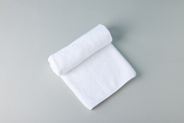 Clean towel on gray background, top view