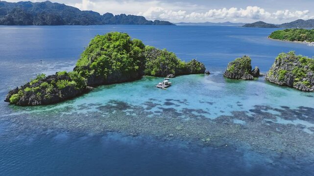 4K Drone View Of Seven Islands of Siete Pecados, Coron island, Palawan, Philippines
showcases the cluster of seven distinct islands surrounded by vibrant blue and crystal clear waters