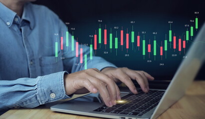 Businessman using laptop computer analyzing sales data and financial growth graph chart...