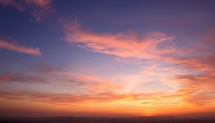 Obraz premium beautiful sunset sky filled with warm shades of orange pink and purple the soft wispy clouds background wallpaper