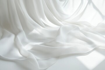 Obraz premium White fabric drapes elegantly with soft light, creating a serene and pure texture. The folds enhance the minimalist composition.