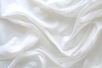 Obraz premium Delicate folds of a pristine white textile cascade, creating a serene and elegant backdrop. Light and shadow enhance the texture.