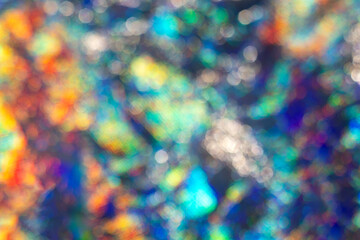 Colorful defocused bokeh background with vibrant light patterns and shimmering effects