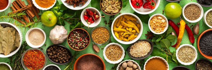 A beautiful collection of colorful spices and herbs, showcasing their natural aromas and vibrant hues on a gentle green background, banner