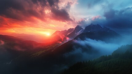 Fototapeta premium Dramatic mountain sunset panorama. Vast, colorful cloudscape over mountain peaks, nestled in misty valleys